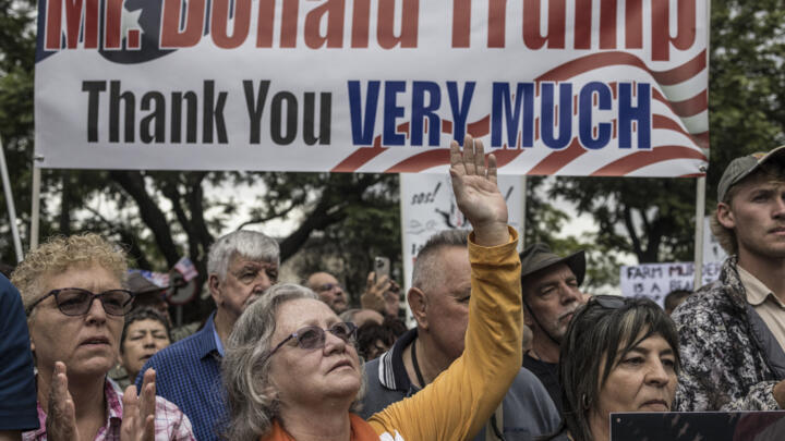 White South Africans supporting US President Donald Trump and South African and US tech billionaire Elon Musk gather in front of the US Embassy in Pretoria, on February 15, 2025.