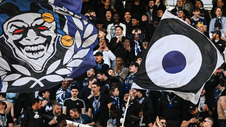 Paris FC's supporters wave flags and cheer during the Ligue 2 football match between Paris FC and Lorient at the Charlety Stadium in Paris on March 8, 2025.
