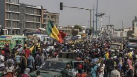 Demonstrators hold Malian flags as they gather in front of the Algerian Embassy in Bamako on April 8, 2025 during a protest.