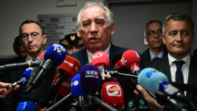 France's Prime Minister Francois Bayrou (C) speaks to the press on April 23, 2025.