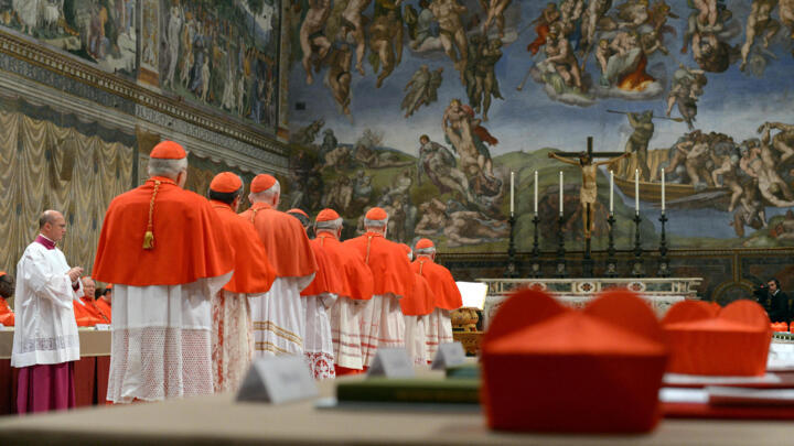 Cardinals queue in the Sistine Chapel to swear on the Bible to never reveal the secrets of their deliberations before the start of the conclave on March 12, 2013. 