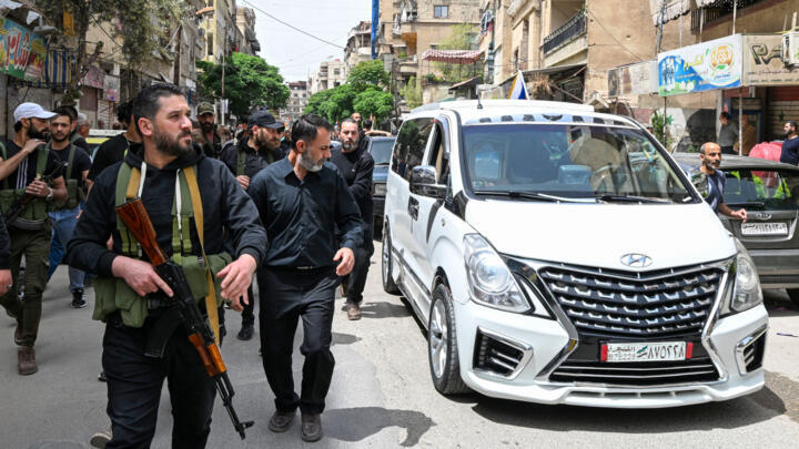 Armed members of Syria's Druze community attend the funeral of seven people killed during overnight clashes with Syrian security forces, in Damascus, on April 30, 2025.