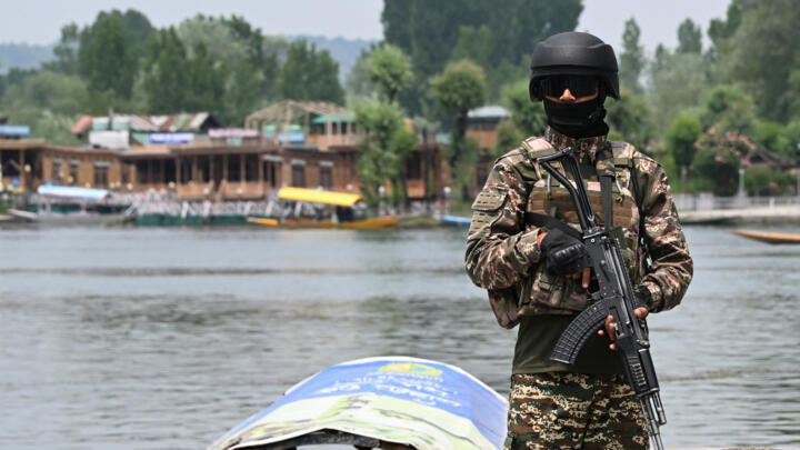 An Indian paramilitary soldier stands guard along the banks of Dal Lake in Srinagar on May 6, 2025.