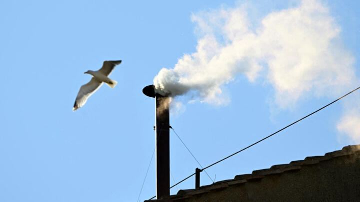 White smoke rising from the chinmey of the Sistine Chapel signaling that cardinals elected a new pope during their conclave in the Vatican on May 8, 2025.