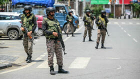 Indian paramilitary soldiers stand guard along a street in Srinagar, a city in the disputed Kashmir region, on May 11, 2025.