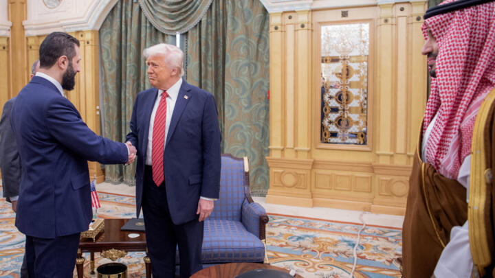 Donald Trump shakes hands with Syria's interim president Ahmed al-Sharaa in Riyadh on May 14, 2025.