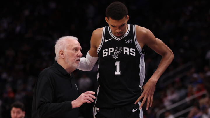 Head coach Gregg Popovich of the San Antonio Spurs talks to Victor Wembanyama on January 10, 2024 in Detroit.