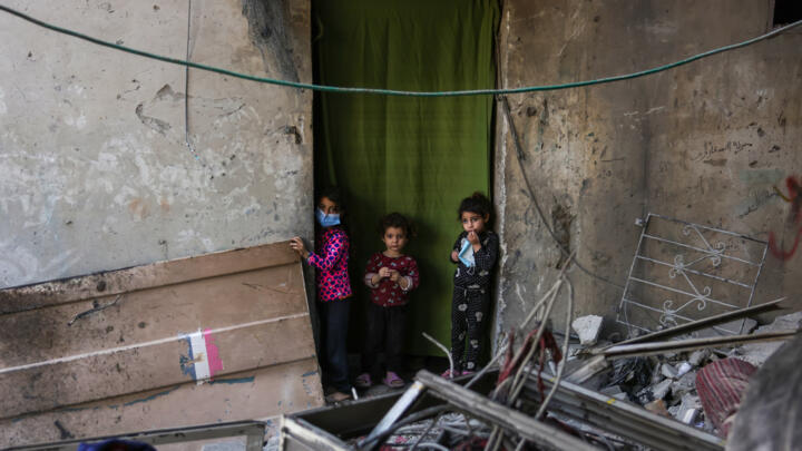 Palestinian children check the site of an Israeli strike in Jabalia.