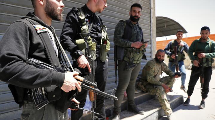 Druze gunmen stand next to a checkpoint a day after deadly clashes between members Druze sect and pro-government fighters in the southern suburb of Jaramana, Damascus on April 29, 2025.