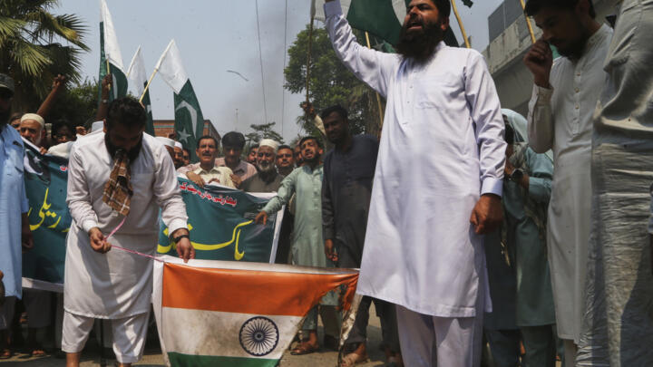 Supporters of Markazi Muslim League party burn an Indian flag during a demonstration to condemn Indian missile strikes, in Peshawar, Pakistan, Wednesday, May 7, 2025.