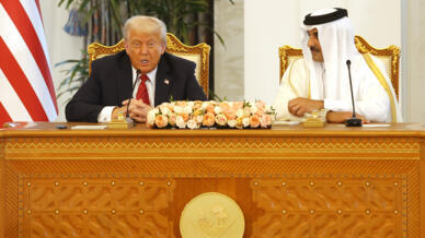 Qatar's Emir Sheikh Tamim bin Hamad al-Thani listens to US President Donald Trump at the Royal Palace in Doha