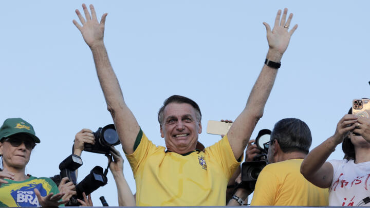 Brazil's former President Jair Bolsonaro waves at supporters during a march to demand amnesty for people convicted over a failed rightwing insurrection on January 8, 2023, in Brasilia, Brazil.