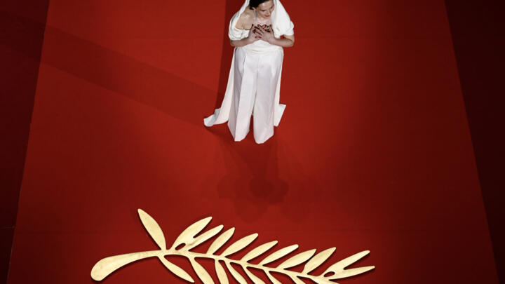 French actress Binoche arrives on stage during the opening ceremony.