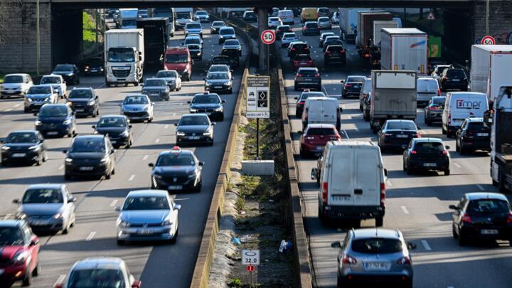 This photograph shows cars driving on the Paris ring road.