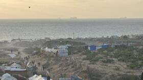 The Gaza coastline near Nuseirat Palestinian refugee camp, with ships in the distance.