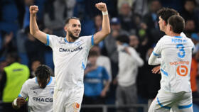 Marseille's Algerian forward #09 Amine Gouiri (L) celebrates after scoring his team's third goal at the end of the French L1 football match between Le Havre AC and Olympique de Marseille (OM) at The Stade Oceane in Le Havre, north-western France, on May 10, 2025. Shortly after the hour mark and opening goal of Marseille, a brawl broke out in a corner adjacent to the Le Havre kop and spectators left the stand to take cover, bringing the match to a halt in the 64th minute and prompting referee Willy Delajod to send the players back to the dressing room.