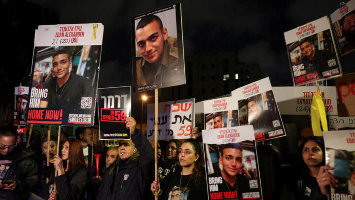 People carry posters with pictures of Edan Alexander, kidnapped during the October 7, 2023 attack on Israel by Hamas, in Jerusalem, April 13, 2025.