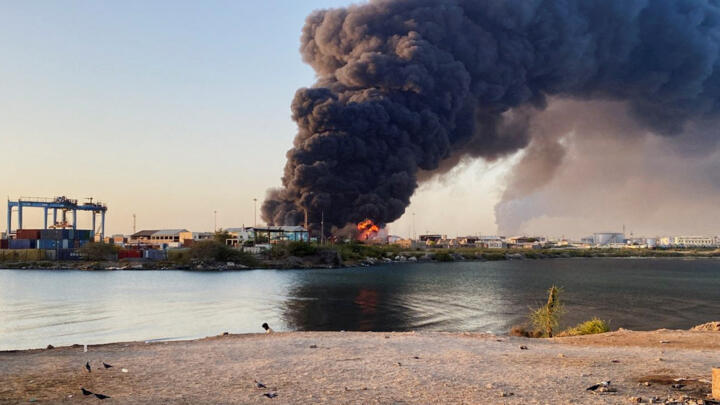 A view shows a large plume of smoke and fire rising from fuel depot in Port Sudan on May 6, 2025.