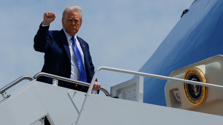 US President Donald Trump gestures as he boards Air Force One bound for Saudi Arabia, Qatar and the United Arab Emirates, Joint Base Andrews, Maryland, May 12, 2025. 